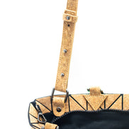 Close-up of a cork handbag with a strap on a white background