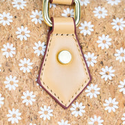 Floral Cork Crossbody Barrel Bag front view with daisy pattern and leather handles