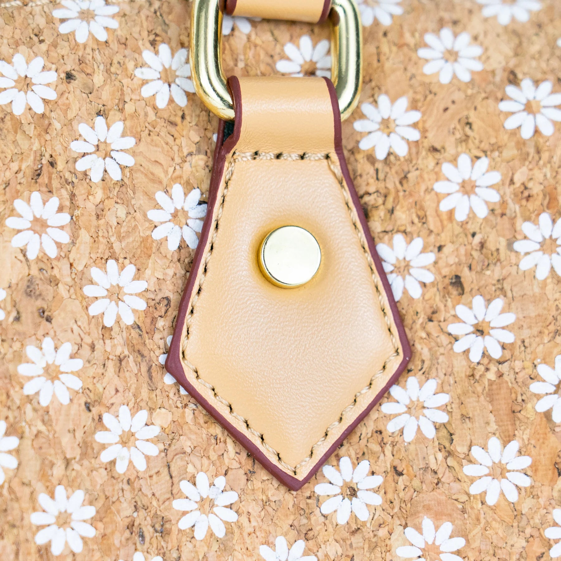 Floral Cork Crossbody Barrel Bag front view with daisy pattern and leather handles