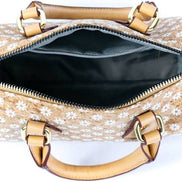 Floral Cork Crossbody Barrel Bag front view with daisy pattern and leather handles