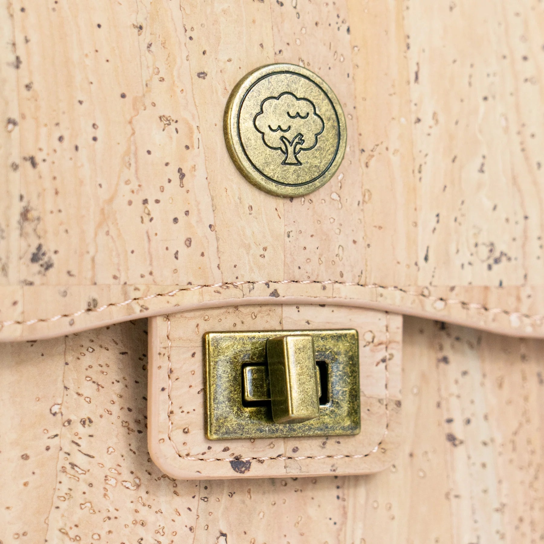 Close up antique brass buck on cork phone bag