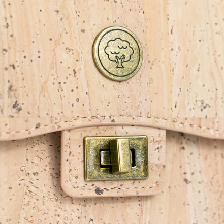 Close up antique brass buck on cork phone bag