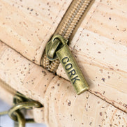 Close up view of antique brass zipper on cork crossbody bag