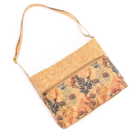 Floral patterned cork bag with a strap on a white background