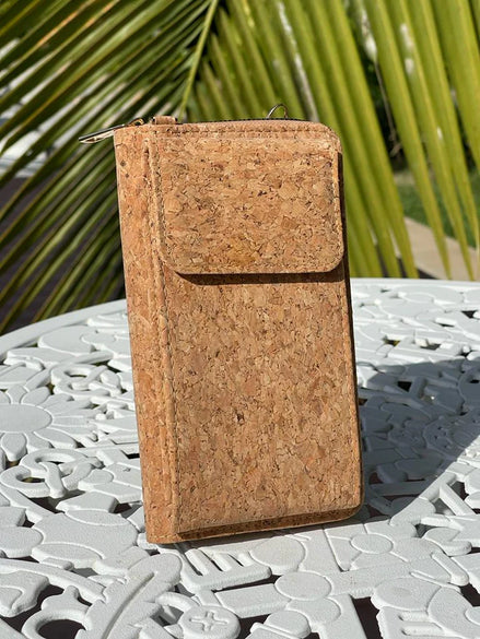 A compact adjustable strap crossbody and wallet in one, designed for hands-free convenience with timeless natural cork texture. 