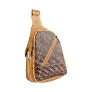 Front view of cork chest sling bag with navy Greek key pattern and slanted zipper pocket.