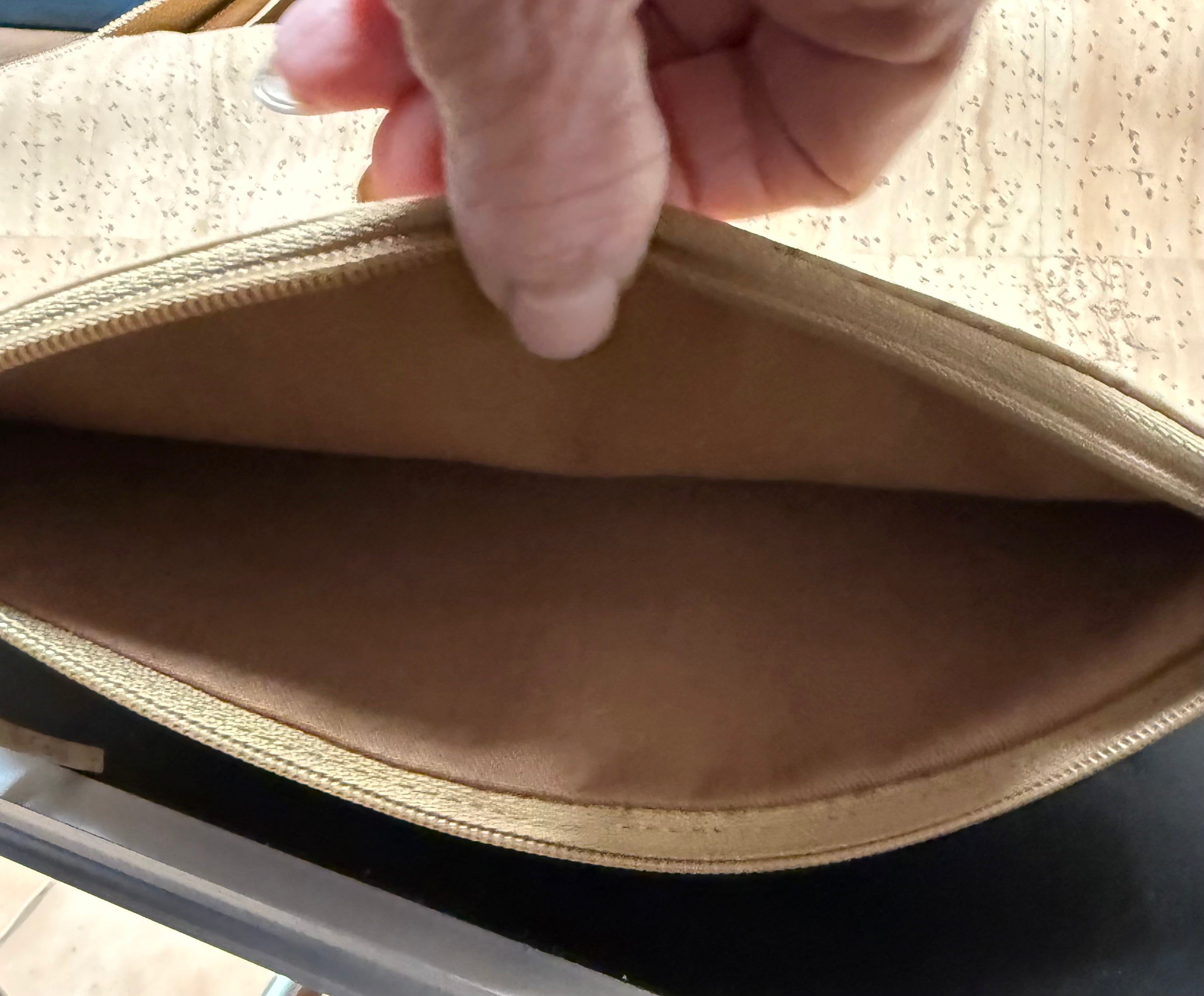 Close-up of a hand opening a cork bag